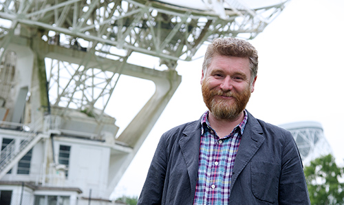 Professor Tim O'Brien in front of the Lovell Telescope