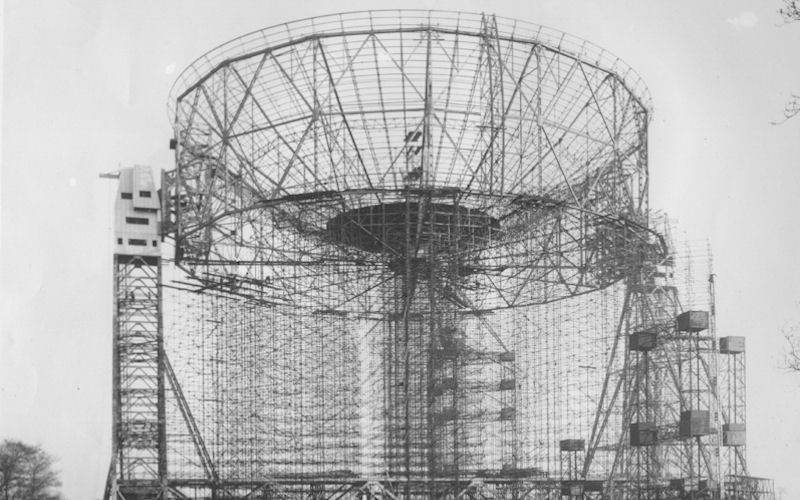 A black and white photograph of The Mark I Telescope under construction in the mid-1950s.