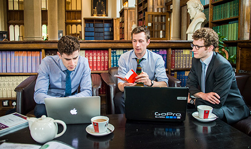 Three prospective employees in discussion in library