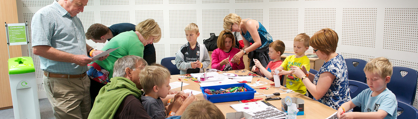 Adults interacting with children in study room