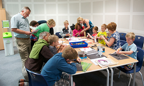 Adults interacting with children in study room