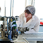 A female student operating accelerator physics equipment