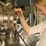 A female researcher operating nanoparticle spectroscopy equipment