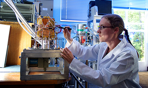 A male scientists works on an accelorator