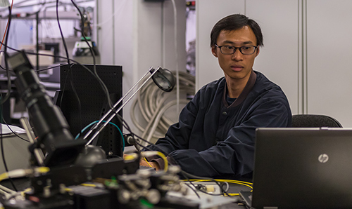 Student in lab focusing on laptop