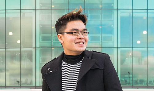 Overseas student smiling in front of a University building