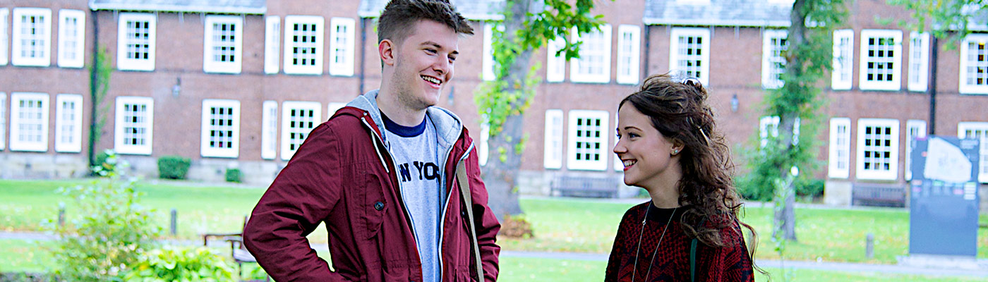 Two students in discussion in field