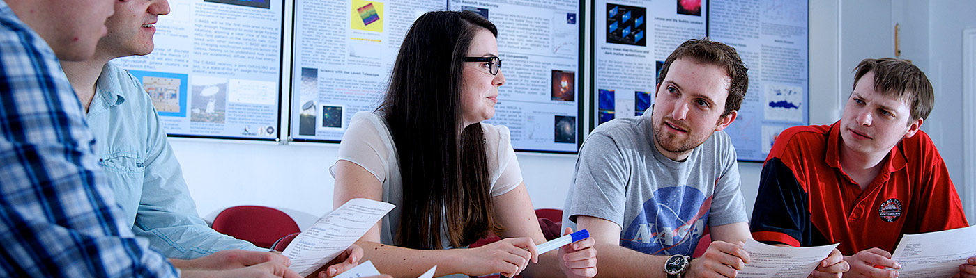 Students sat around a table in discussion during a tutorial 